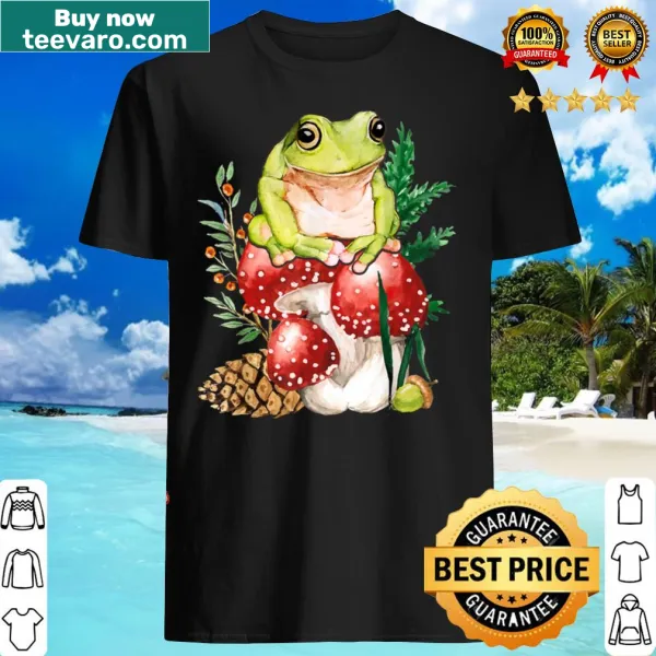 Illustrated T-shirt featuring cute frogs and mushrooms in a cottagecore style.