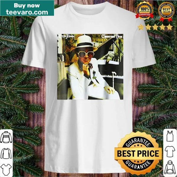 Vintage-style shirt with 'Greatest Hits' text and retro graphics.