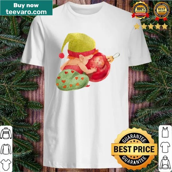Cheerful elf baby looking into a Christmas ball illustration on a T-shirt.
