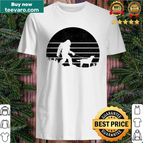 Funny shirt with Bigfoot walking a Labrador illustration.