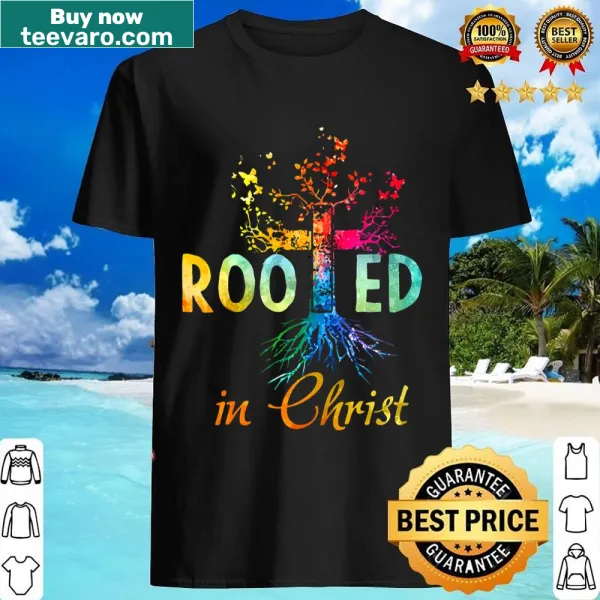 Inspirational shirt with 'Rooted In Christ' message and rainbow art.