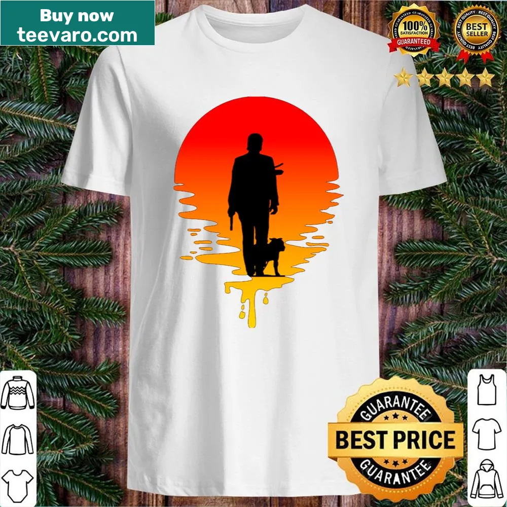 Silhouette of John Wick against a sunset background