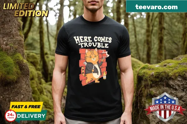 Cartoon cat design with the phrase 'Here Comes Trouble'