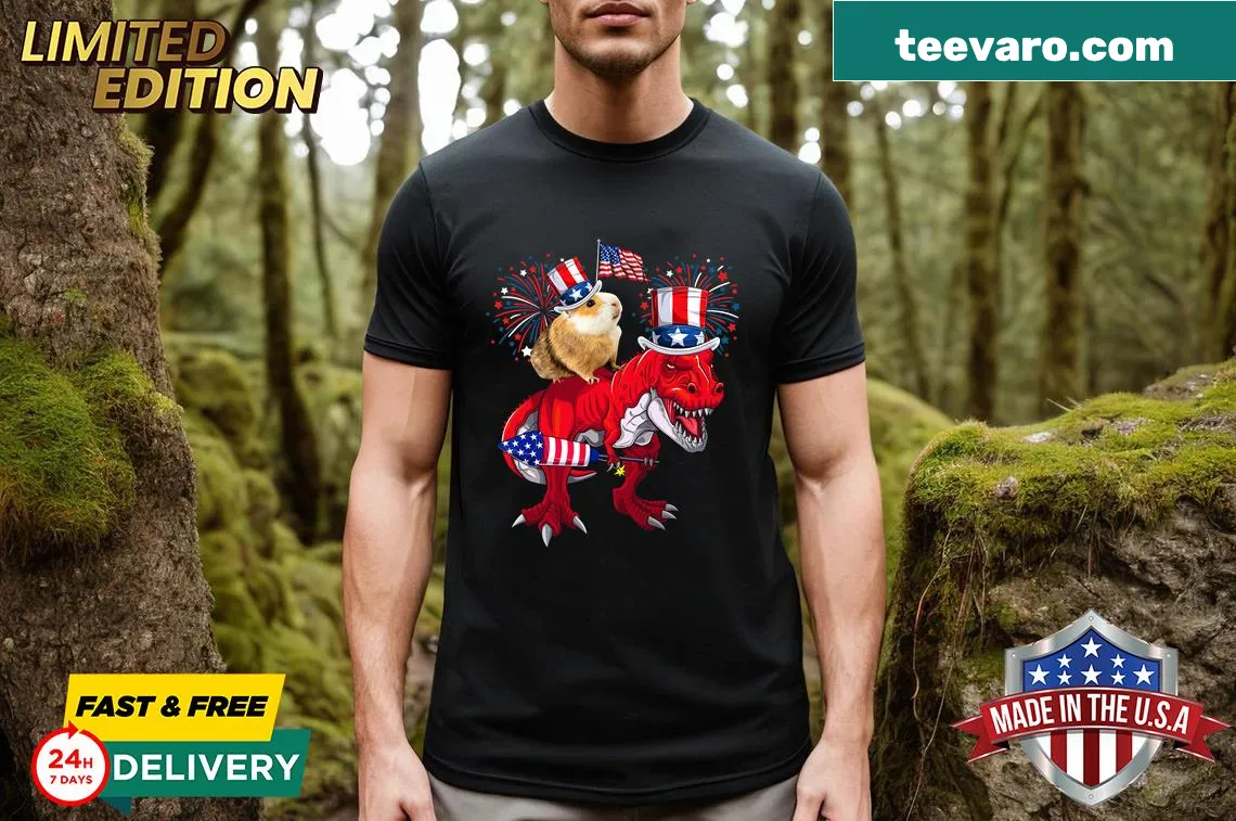 Funny tee featuring a guinea pig riding a T-Rex with fireworks for July 4th. — on a men's t-shirt