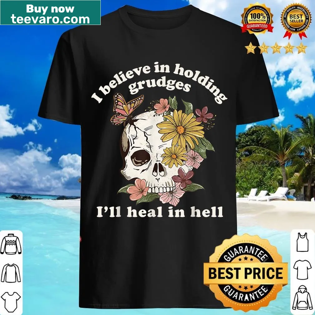 Floral skull design with the phrase about holding grudges and healing in hell. — on a men's t-shirt