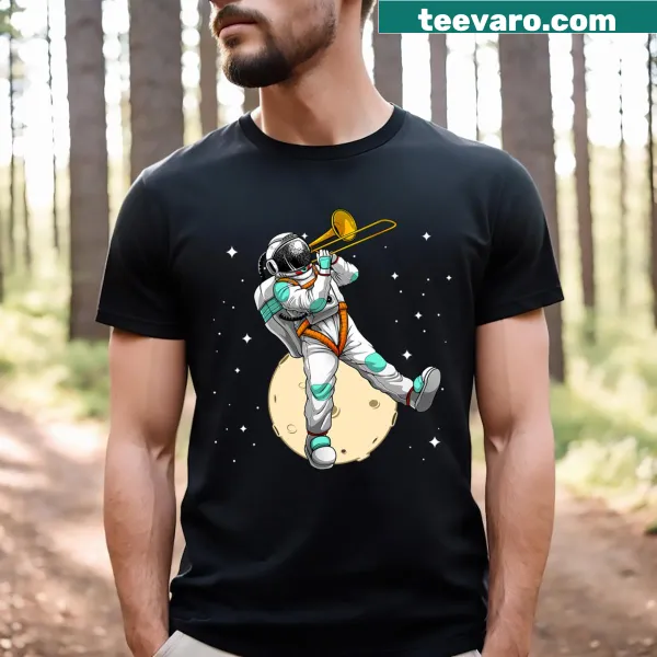 Cartoon astronaut playing trombone in space graphic T-shirt.