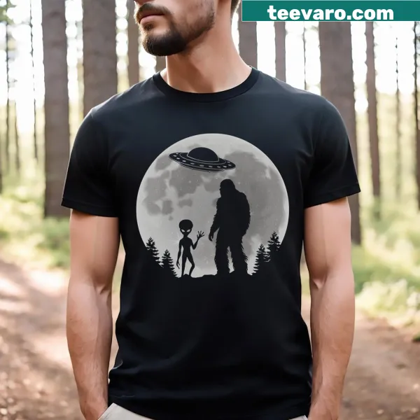 Cartoon t-shirt featuring aliens, Bigfoot, UFOs, and a playful design.