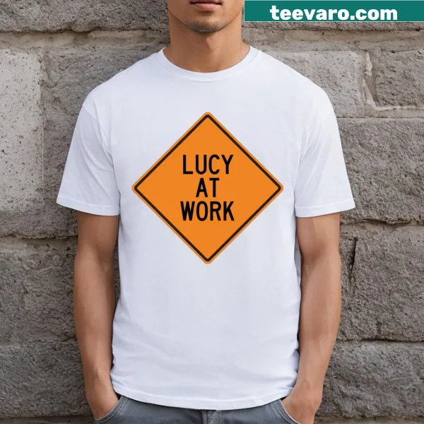 Funny warning sign graphic T-shirt that reads 'Lucy At Work.'