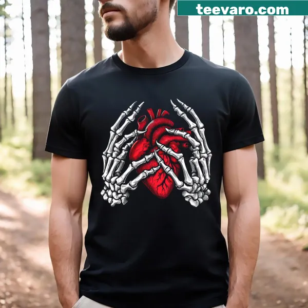 Skeleton hands holding a heart graphic on Halloween-themed shirt.