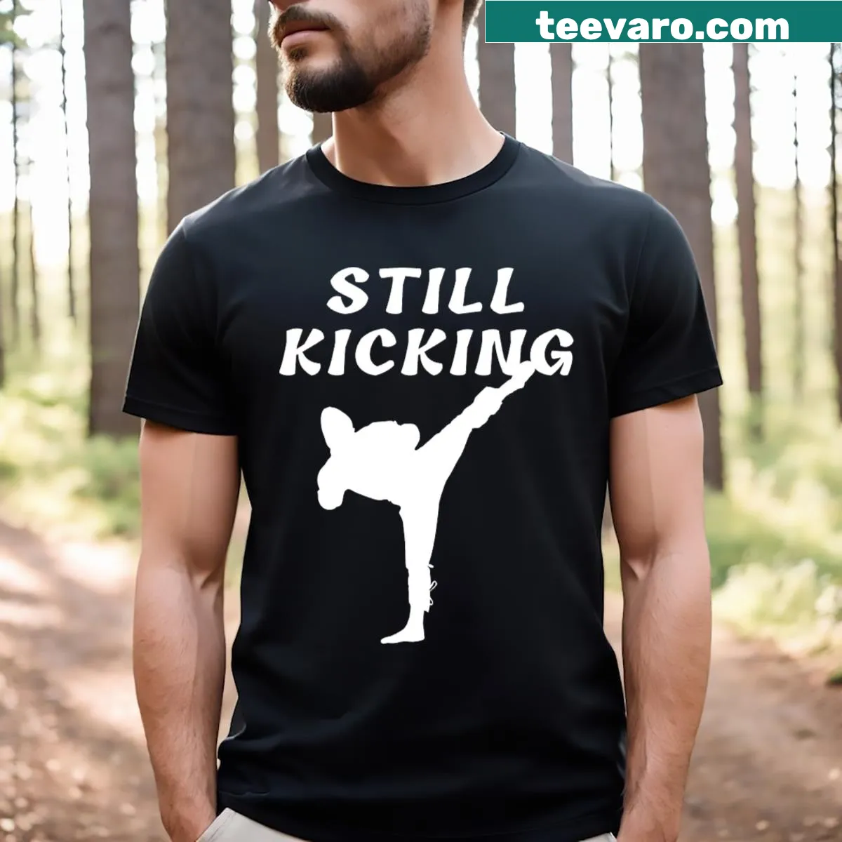 T-shirt featuring the phrase 'Still Kicking' in bold text — on a men's t-shirt