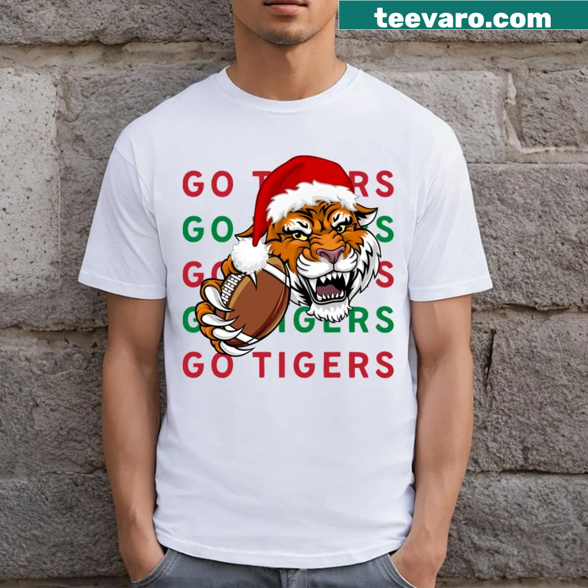 Playful T-shirt featuring a tiger with a football and a Christmas hat. — on a men's t-shirt