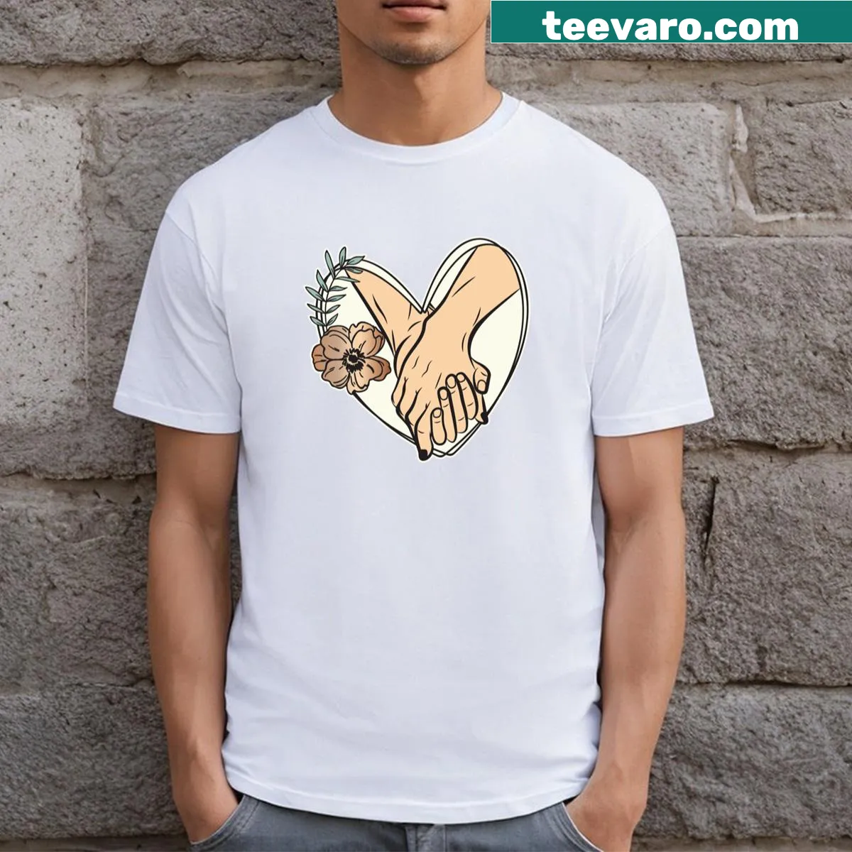Couple holding hands surrounded by a heart illustration on a T-shirt. — on a men's t-shirt