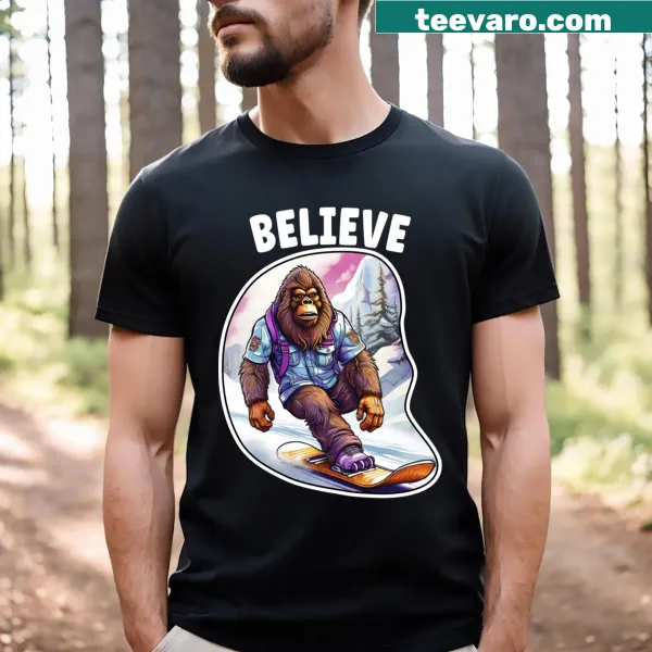 Illustrative t-shirt of Bigfoot snowboarding with 'Believe' text