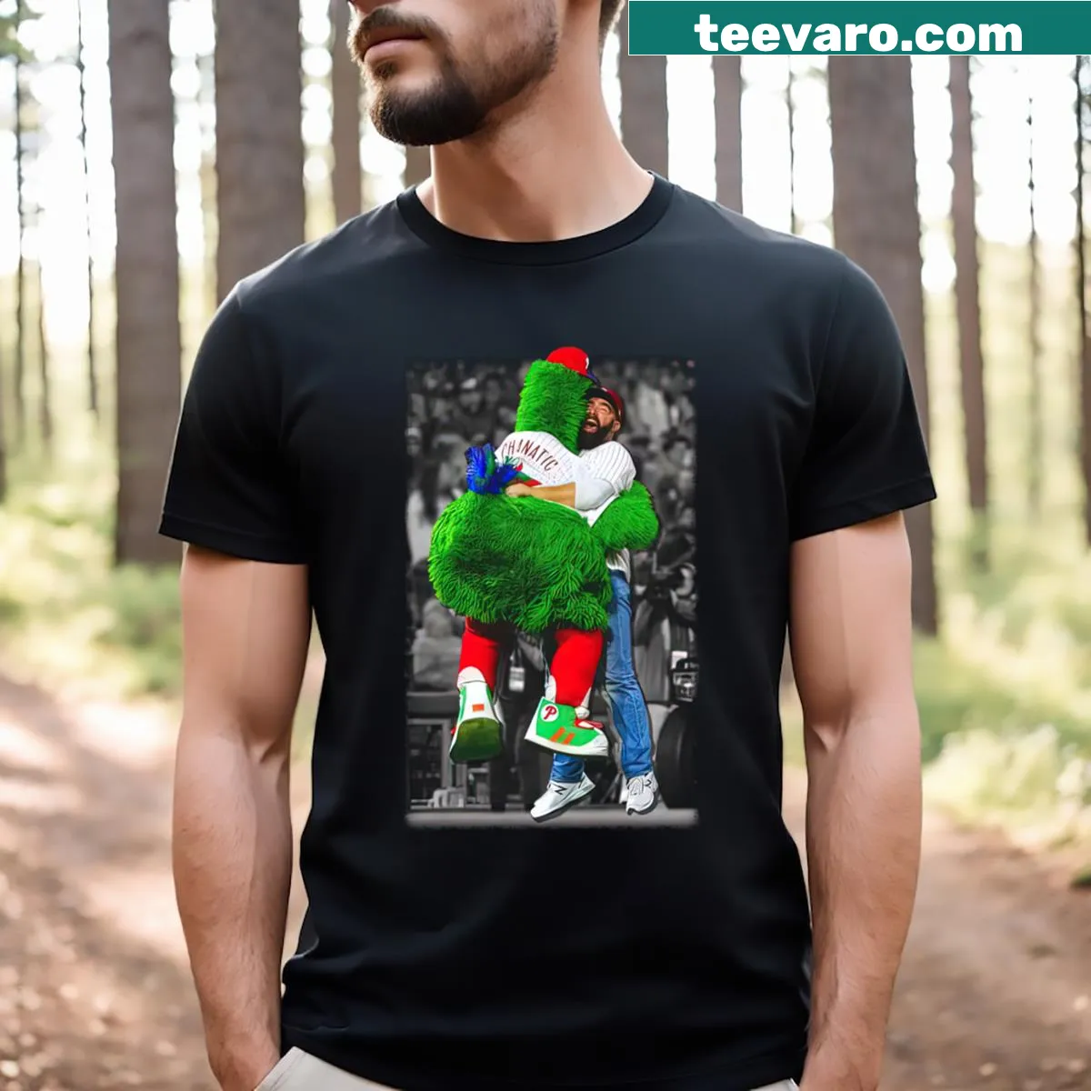 T-shirt featuring Jason Kelce hugging the Philly Phanatic in a playful illustration — on a men's t-shirt