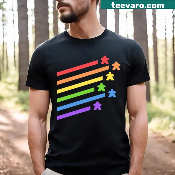 Cartoon graphic of colorful meeples on a board games T-shirt.