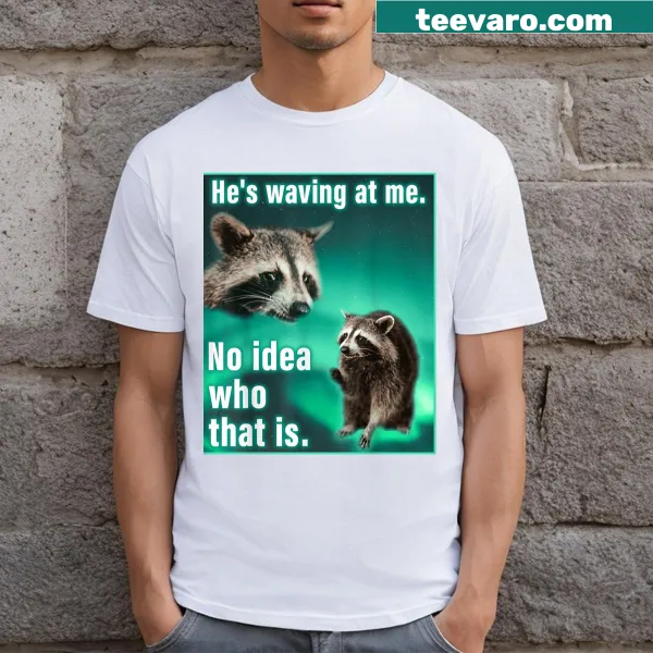Funny raccoon meme t-shirt with cartoon waving raccoon and text