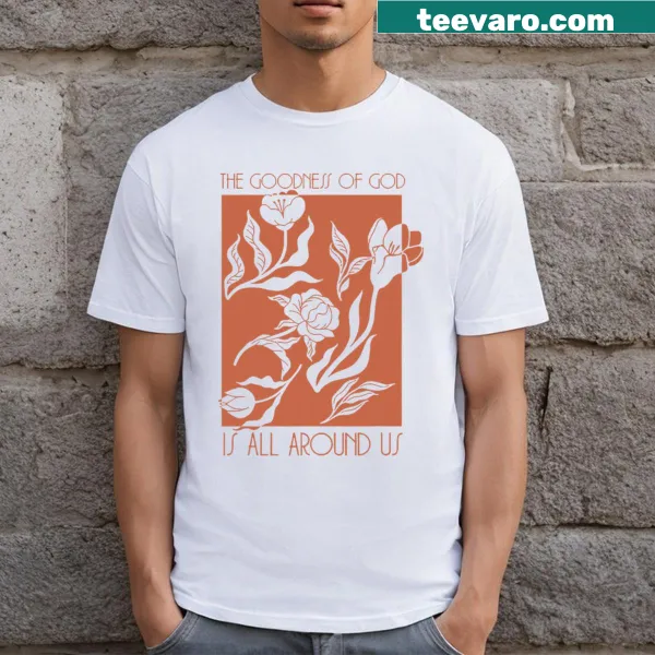 Inspirational typography with the phrase 'Goodness Of God Is All Around Us' on a t-shirt