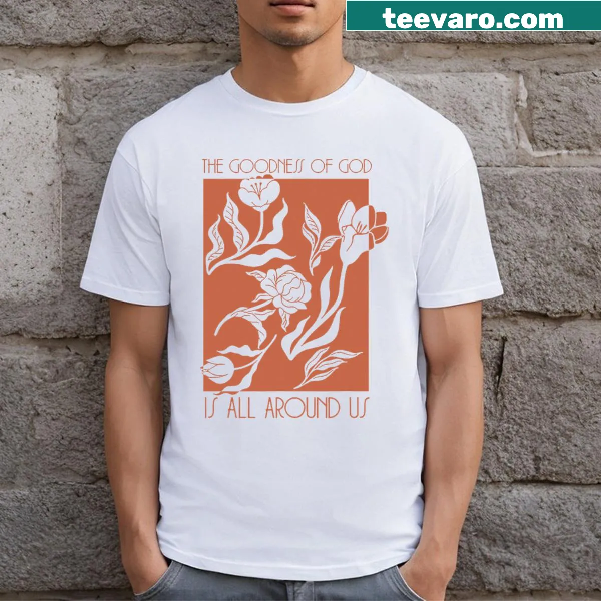 Inspirational typography with the phrase 'Goodness Of God Is All Around Us' on a t-shirt — on a men's t-shirt
