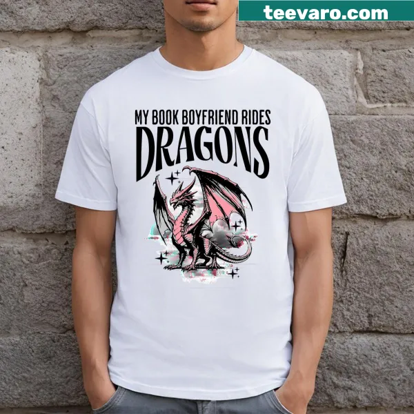 Humorous T-shirt with text 'My Book Boyfriend Rides Dragons' and cartoon graphic