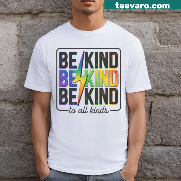 Retro style T-shirt featuring the LGBTQ+ rainbow flag and 'Be Kind' text.