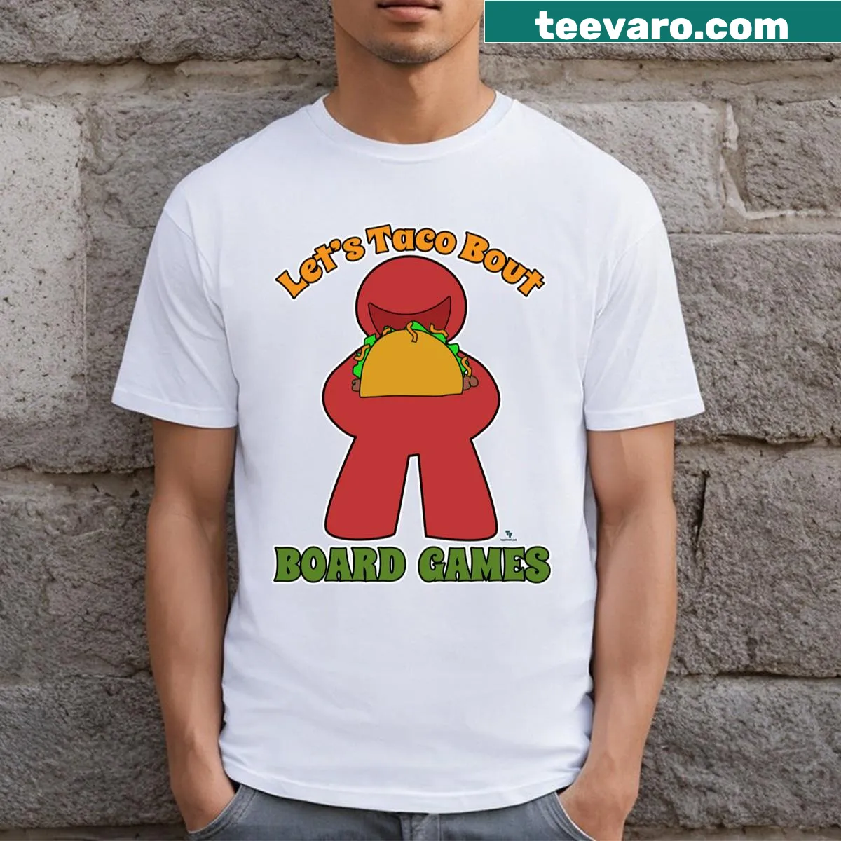 Cartoon graphic of tacos and board game meeple on t-shirt — on a men's t-shirt