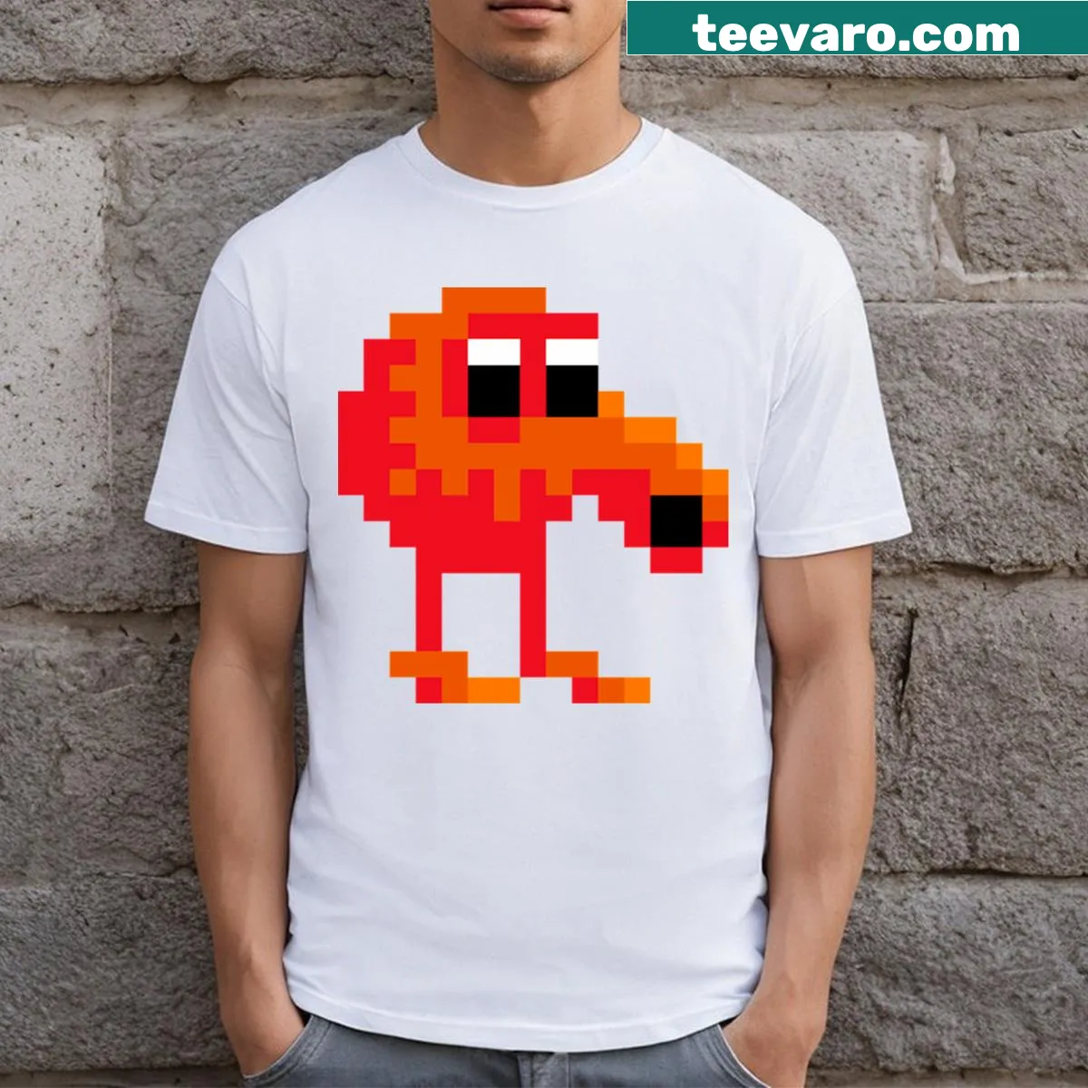 T-shirt featuring a cartoon graphic of Qbert from classic gaming — on a men's t-shirt
