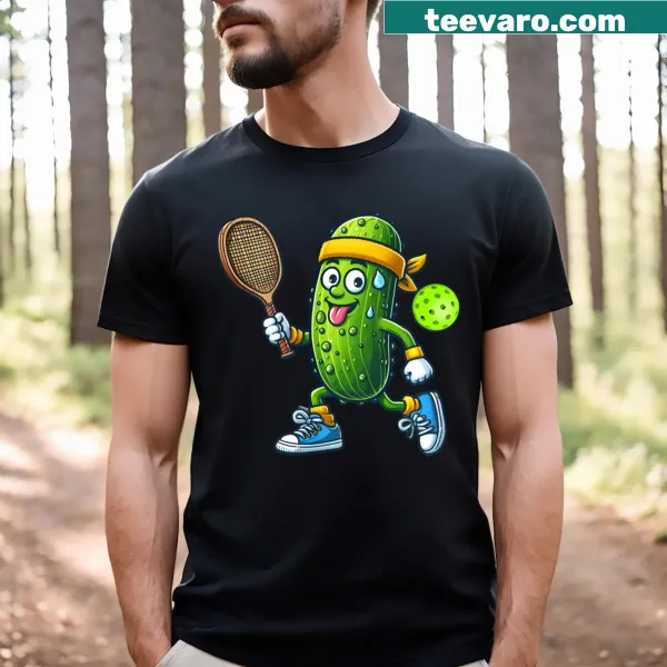 Cartoon T-shirt featuring a pickle playing pickleball