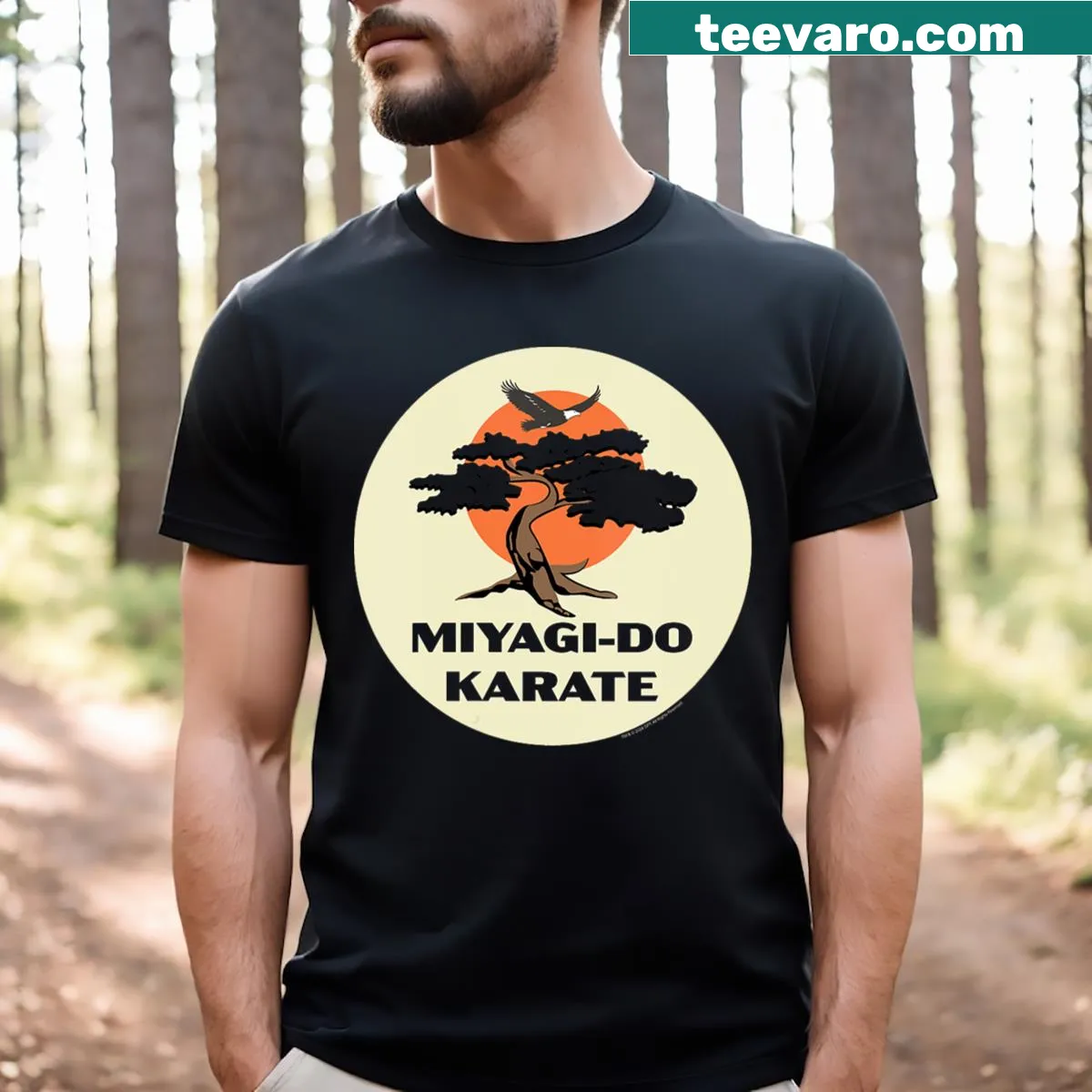 Cobra Kai and Miyagi Do logos with eagle and bonsai tree illustration on shirt — on a men's t-shirt