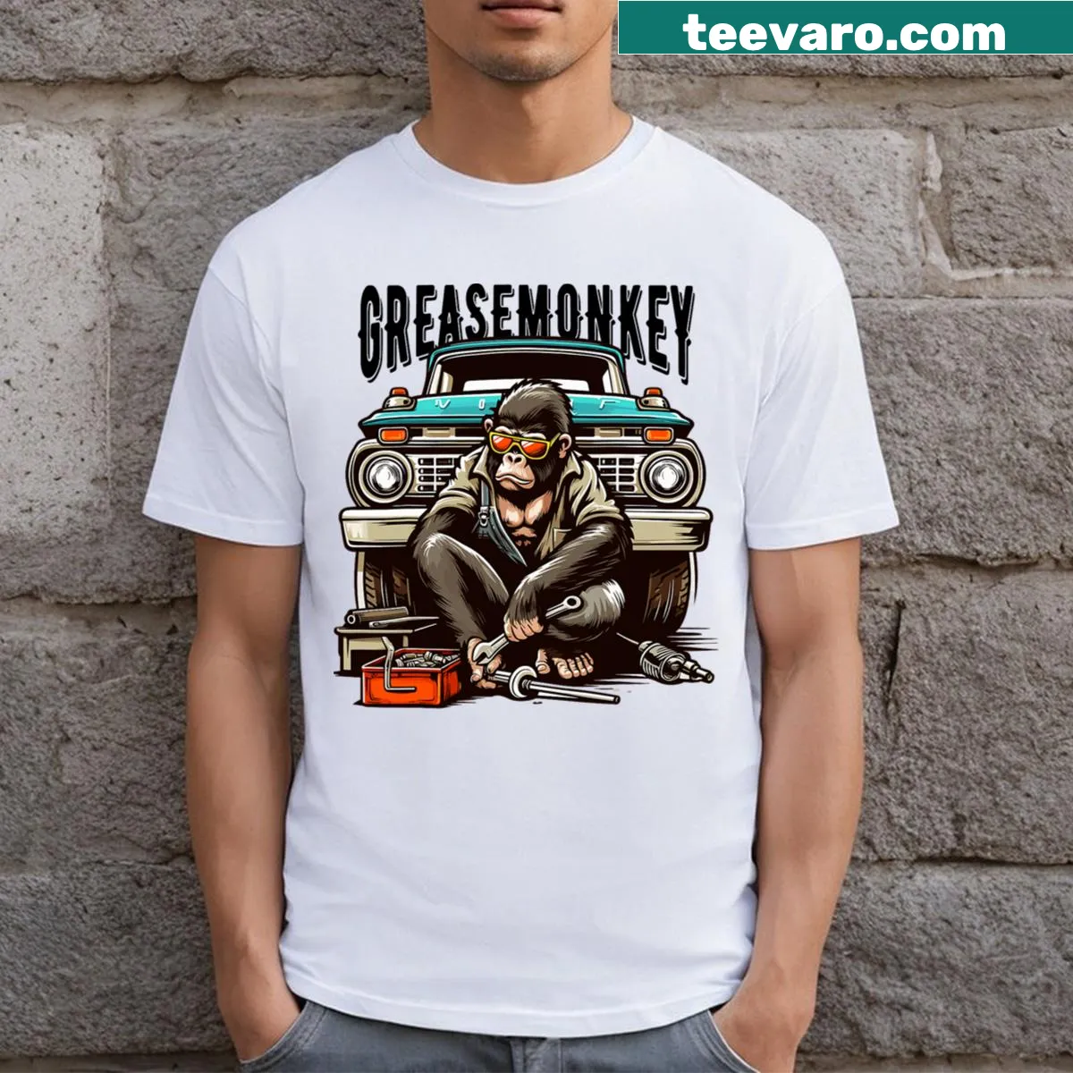 Graphic of a grease monkey with sunglasses working on a vintage truck — on a men's t-shirt