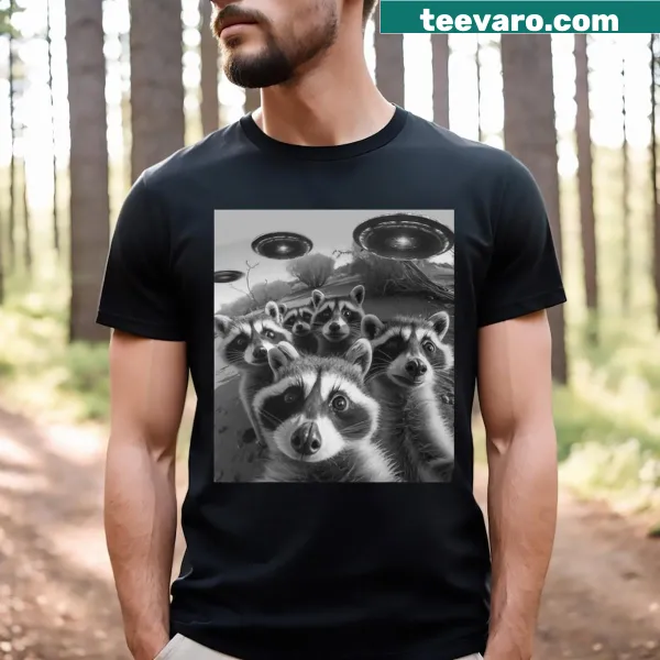 Funny cartoon raccoon taking a selfie with a UFO on a t-shirt