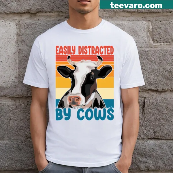 Cartoon cow graphic with the phrase 'Easily Distracted By Cows' on t-shirt