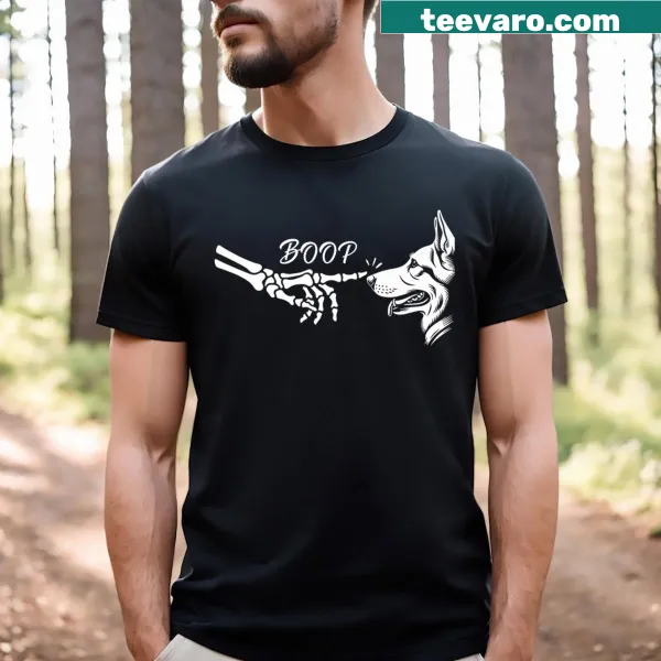 Skeleton hand booping a German Shepherd on a Halloween T-shirt