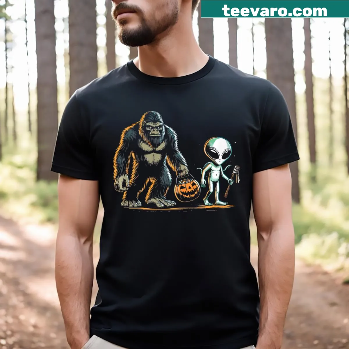 Playful Halloween graphic featuring Bigfoot and aliens trick-or-treating — on a men's t-shirt