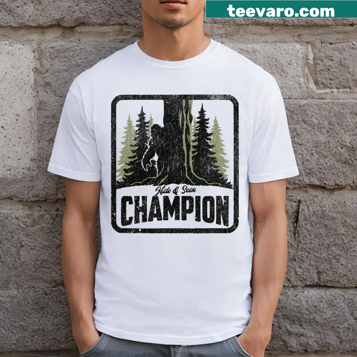 Funny Bigfoot t-shirt featuring 'Hide and Seek Champion' text and illustration — on a men's t-shirt