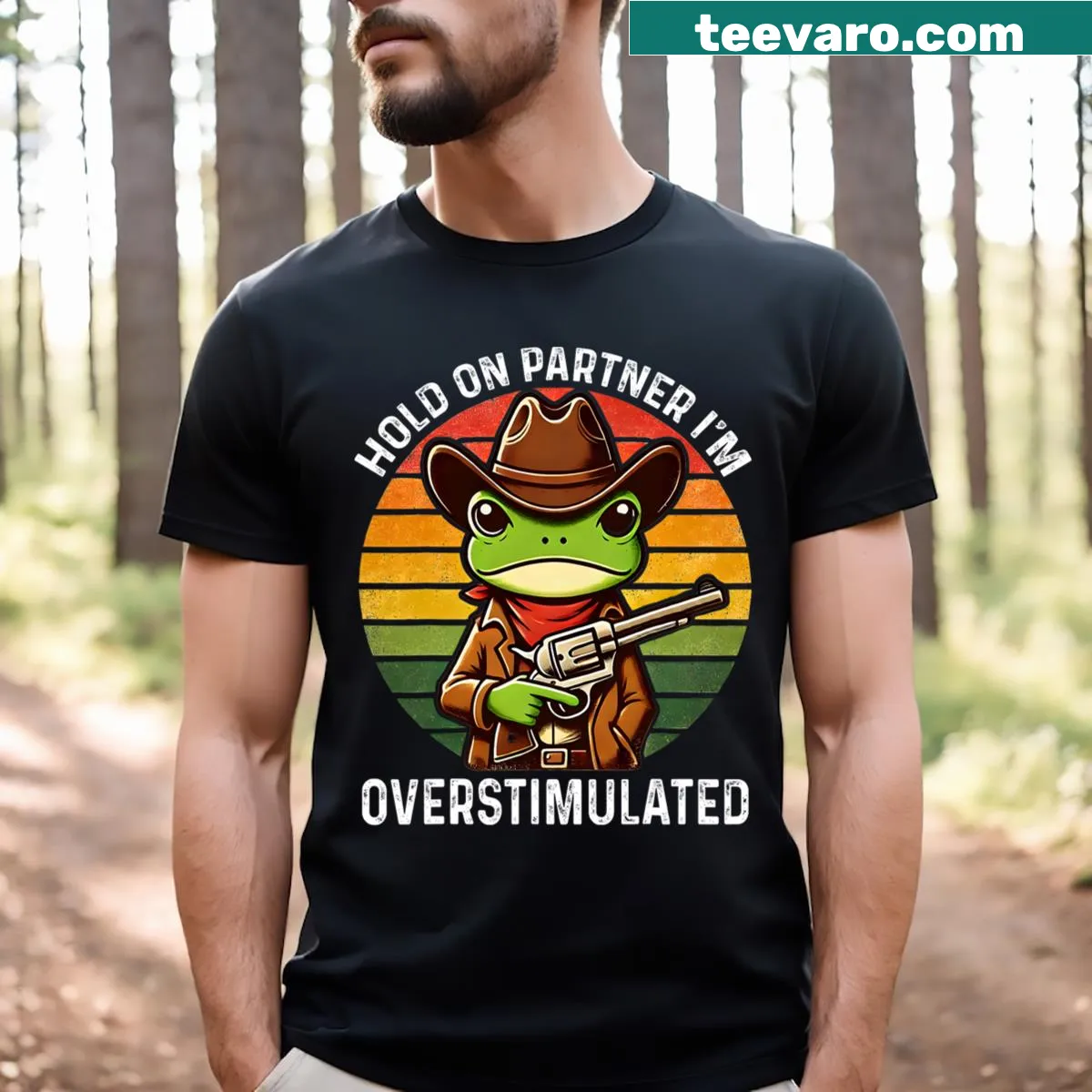 Funny t-shirt featuring a cartoon cowboy frog saying 'Hold On Partner I'm Overstimulated' — on a men's t-shirt
