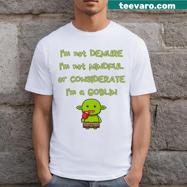 Graphic T-shirt featuring a whimsical goblin and the phrase Not Demure