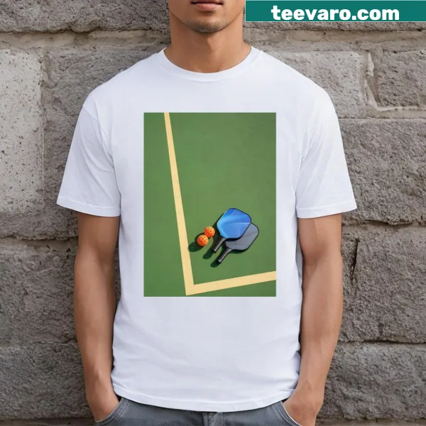 Realistic graphic of a pickleball paddle and ball on a T-shirt