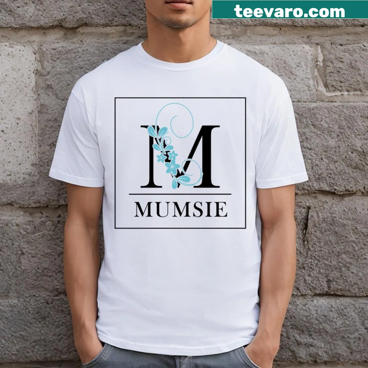 Floral letter M design in a light blue frame — on a men's t-shirt