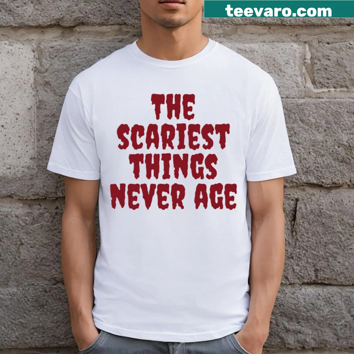 Vintage horror graphic with text on a T-shirt, saying 'The Scariest Things Never Age' — on a men's t-shirt