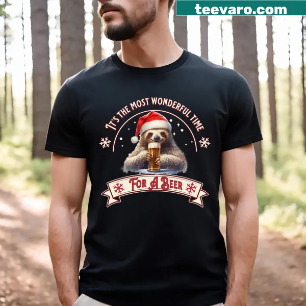 Funny Christmas T-shirt featuring a sloth holding a beer