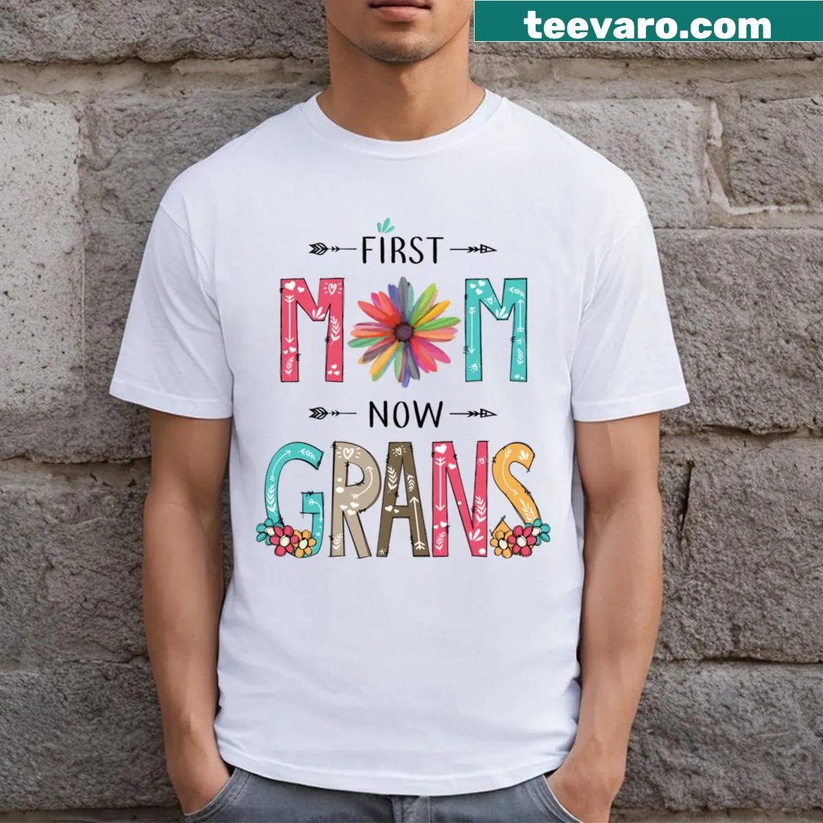 Graphic T-shirt with wildflowers and 'First Mom Now Grans' text — on a men's t-shirt
