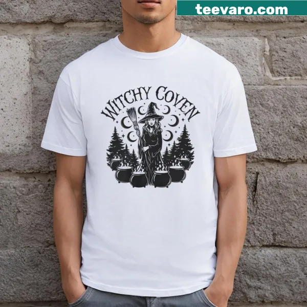 T-shirt featuring a whimsical illustration of witches in a coven