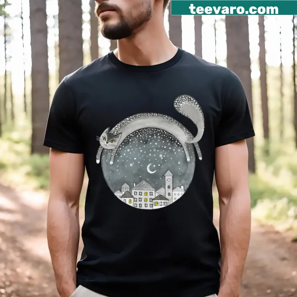 T-shirt featuring an illustration of a cat overlooking a night town.