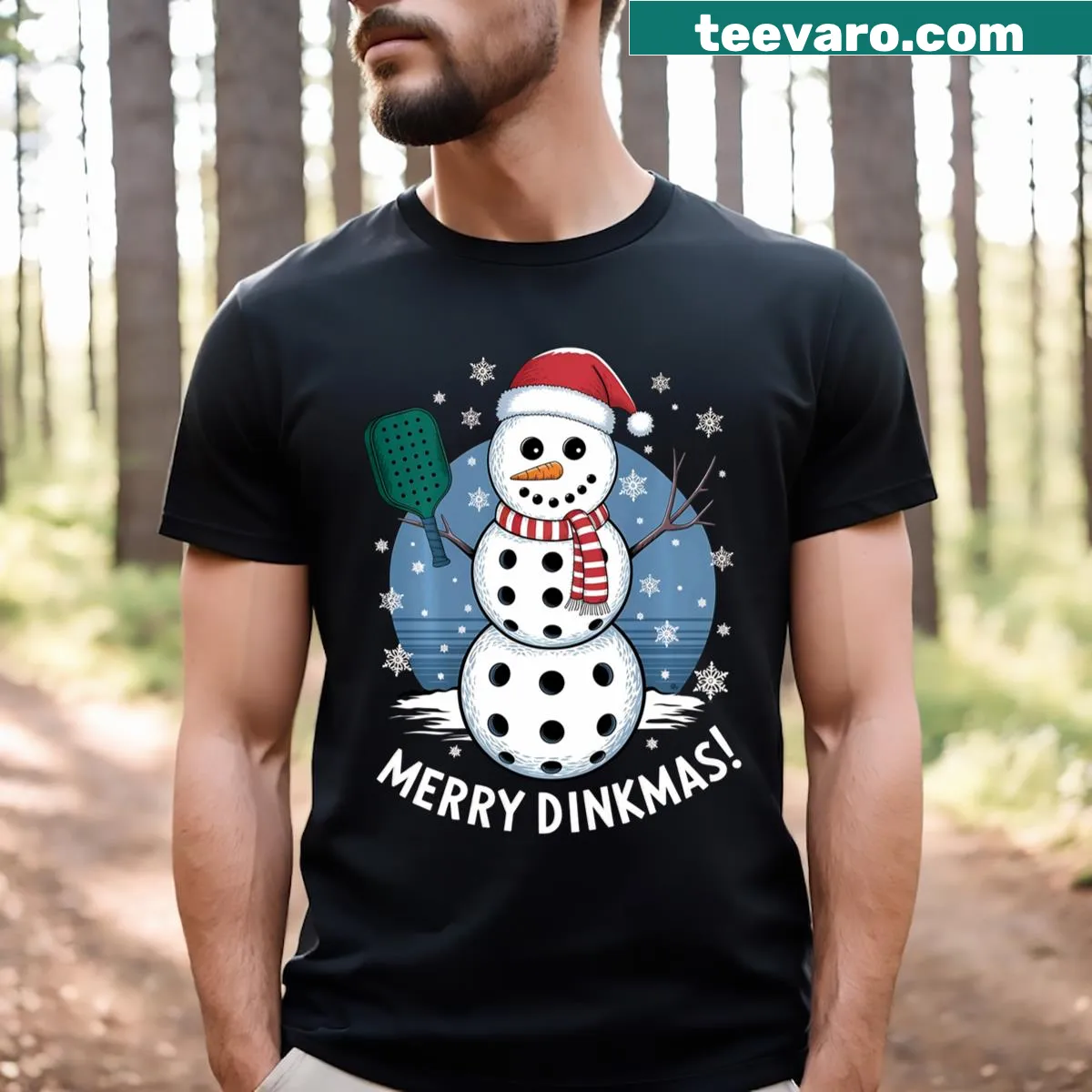 Snowman in Santa hat holding a pickleball paddle on t-shirt — on a men's t-shirt