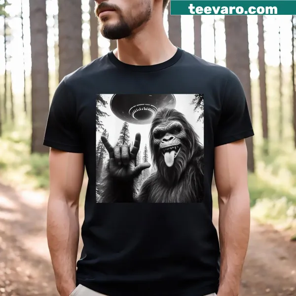 Cartoon Sasquatch taking selfie with UFO and alien on a T-shirt
