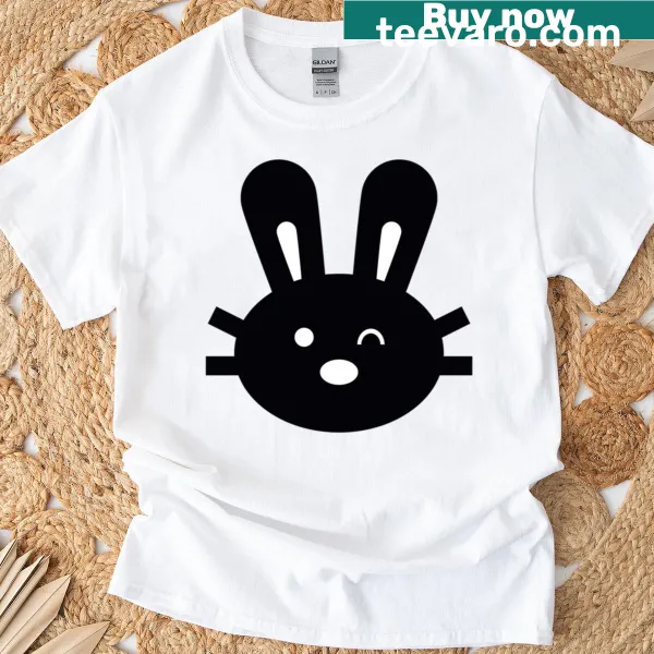 T-shirt featuring cartoon bunnies dropping vegetables in a humorous design.