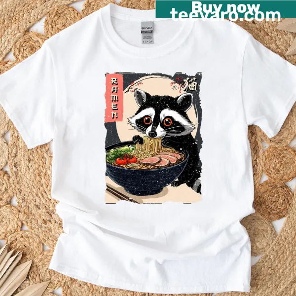 Cartoon raccoon devouring ramen noodles on T-shirt.