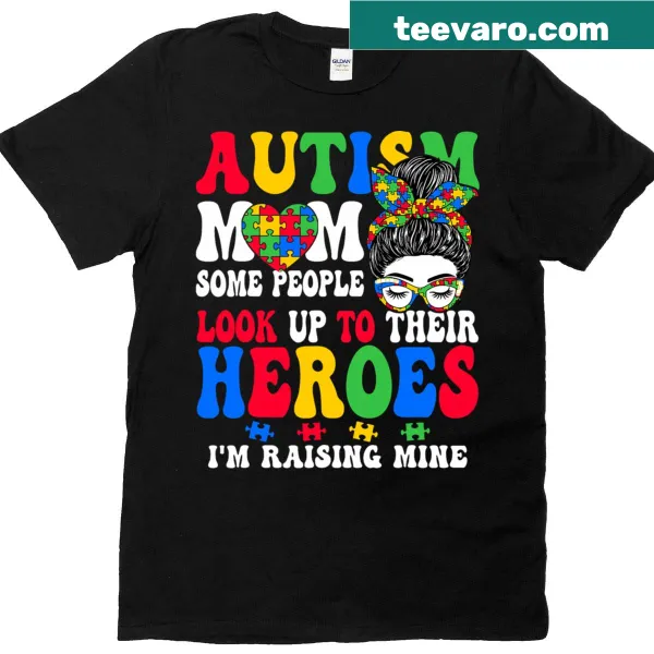 T-shirt featuring 'Raising a Hero' with a messy bun graphic, celebrating autism awareness.