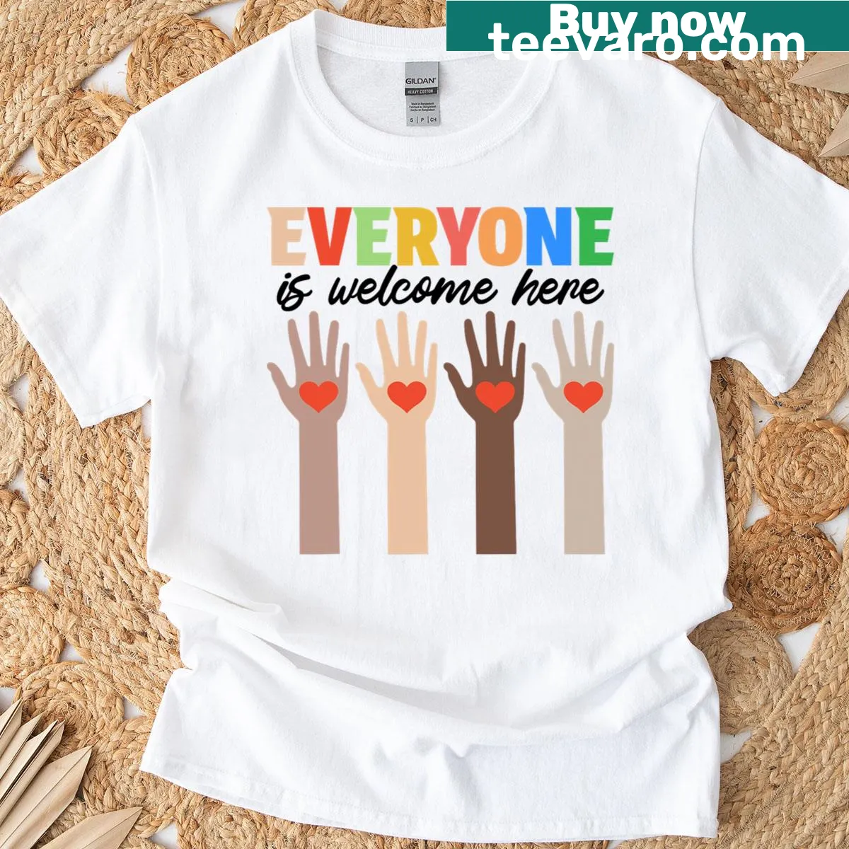 Fist graphic with text Everyone Is Welcome Here on teacher t-shirt — on a men's t-shirt