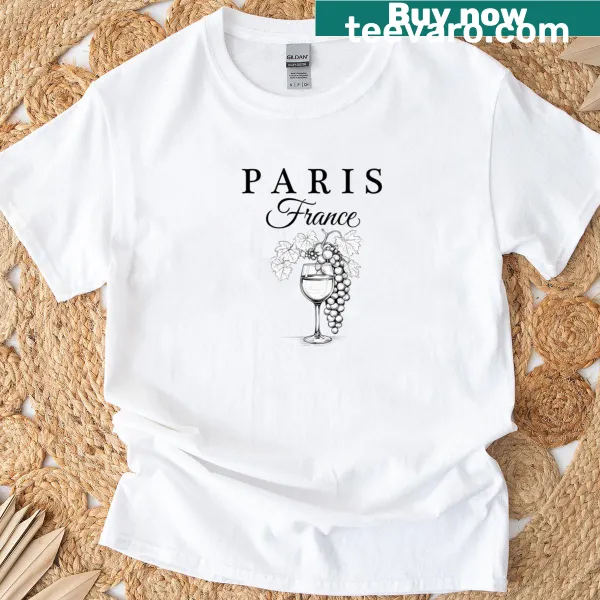 T-shirt depicting Paris skyline with wine bottle and glass.